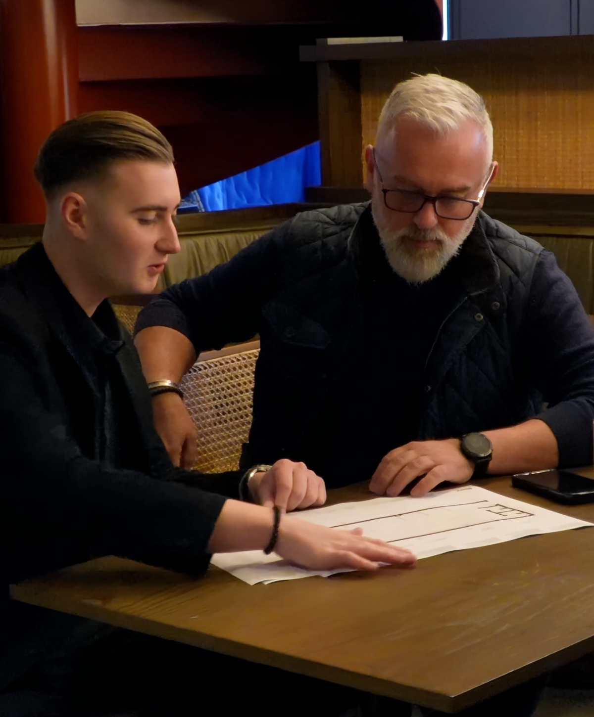Architectural drawings and building permit documents being reviewed before a building permit application